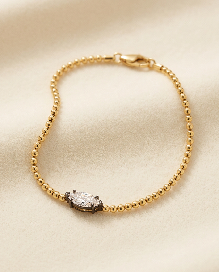 Celeste marquise bracelet arranged alone on a softly textured ivory studio surface