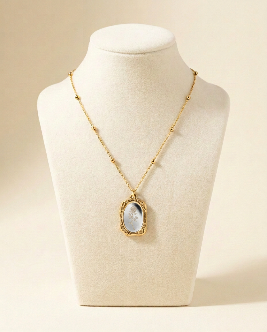 Rosalie necklace with a rose motif on a white-grey mirror-effect oval pendant, framed in gold tone on a beaded chain